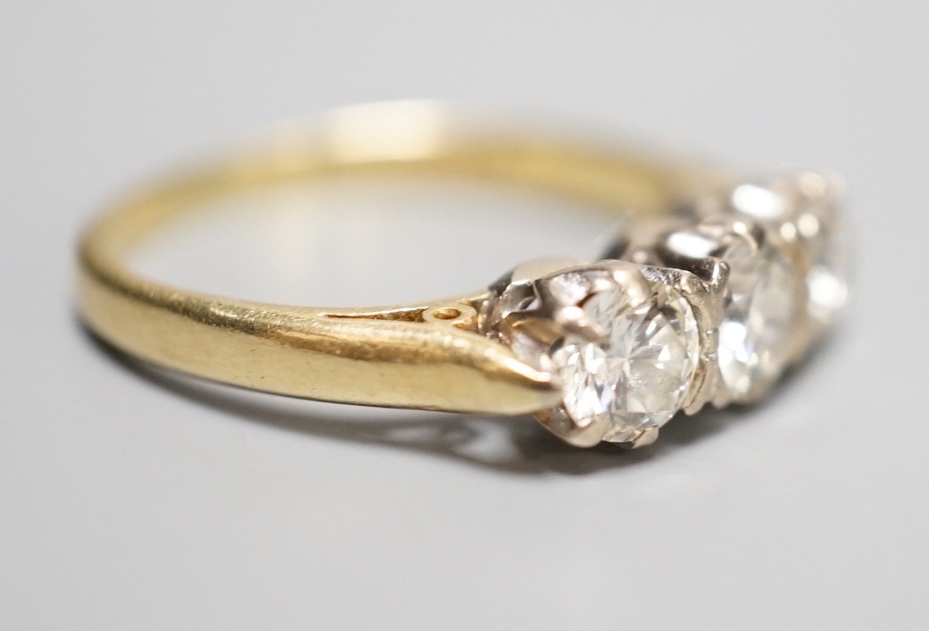 A modern 18ct gold and three stone diamond ring, size L, gross weight 3.3 grams